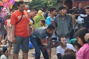 Salah seorang pengunjung saat dicium ikan dewa.